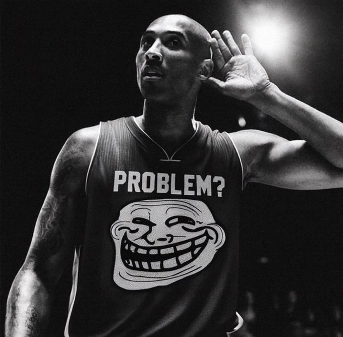 "Troll", as seen in the picture, has been replaced with a different character or an animal. The image appears to be a black and white photo that shows someone looking up at the camera while making a funny face (as if the character or animal is also laughing) wearing the same shirt they were originally dressed for basketball. The post references this person's life as a basketball player, implying that their current situation might involve being replaced by another player due to their performance on the court. The image seems to be sharing a humorous story about someone experiencing this change in their basketball career.