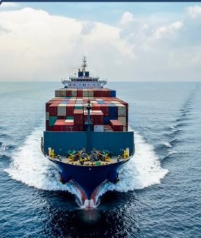 A large blue and red container ship sails through the open ocean, viewed from above.