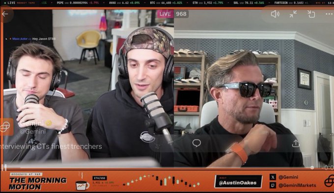 A livestream screenshot from "The Morning Motion" show featuring hosts Gemini and a guest wearing sunglasses, with the caption "Interviewing CT's finest trenchers" displayed as they're conducting an interview about crypto/Solana plays like $TBB. The "LIVE 968" viewer count and stock ticker at the top confirm it's a financial markets broadcast discussing Solana-related opportunities.