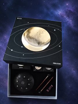 An HBX jewelry box with a moon-themed lid displayed against a cosmic background, opened to reveal watches and accessories inside.