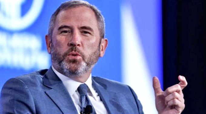Chris Larsen, co-founder and executive chairman of Ripple, is shown mid-gesture while speaking at an event. The image relates to the accompanying news that Ripple has made a strategic investment in Notabene, a transaction network handling $2 trillion annually across 2,300 institutions in 100+ jurisdictions.