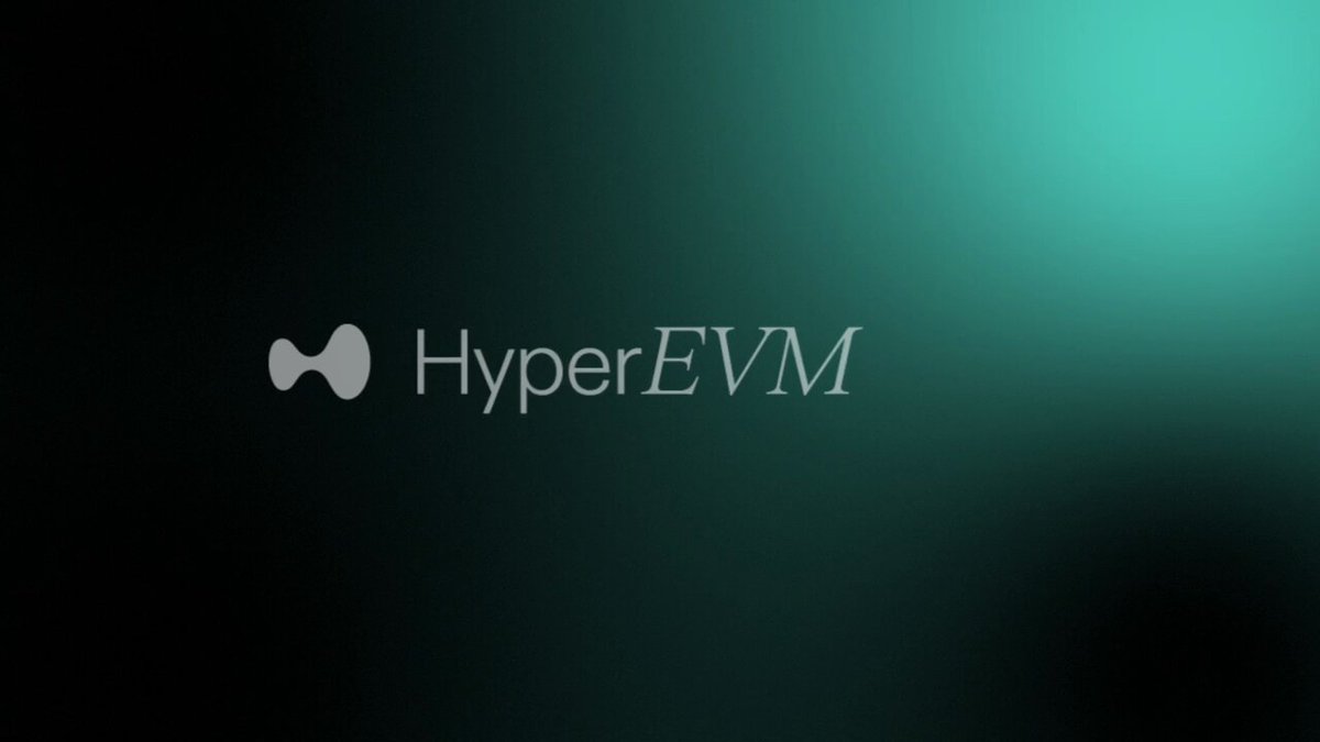 The image features a logo for HyperEVM, which is displayed against a black background. The logo consists of a white "H" shape positioned above the word "HyperEVM". Below this, there's a small gray arrow pointing towards the "EVM" part of the logo. The text "HYPEREVM" is written in a larger font size than the "H" and the arrow, making it stand out against the black background.