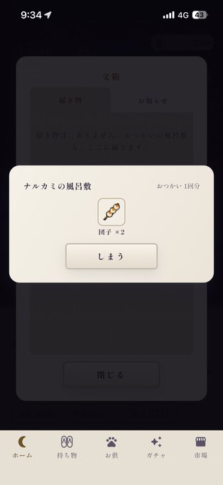 A mobile phone screen displays a Japanese app interface with a pop-up dialog titled "ナルカミの風呂敷" showing a reward of a narutomaki (fish cake) icon with "団子 × 2" and a "しまう" button.