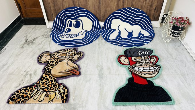 Four decorative rugs displayed on a marble floor, including two circular blue rugs and two character-shaped rugs depicting a leopard-like figure and a monkey-like character wearing a 'RAW' cap.