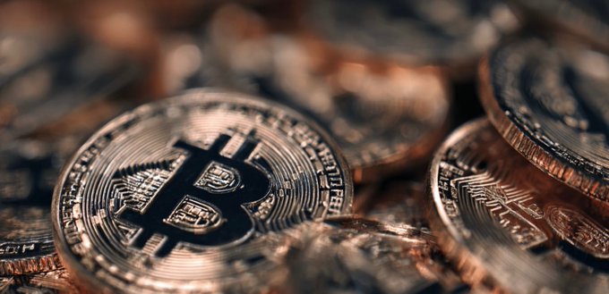 A pile of Bitcoin coins with the iconic "₿" symbol prominently displayed in the foreground, representing Capital B's plan to expand its Bitcoin treasury by acquiring 376 BTC backed by Adam Back's $8.8M investment.