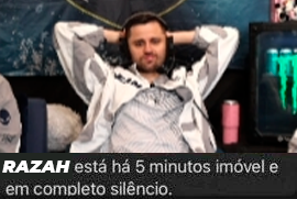 A bearded man sits back in his chair with his hands behind his head; Portuguese text below reads "RAZAH está há 5 minutos imóvel e em completo silêncio."
