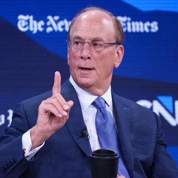 A man in a dark suit and blue tie gestures with his index finger raised while speaking at a podium, with "The New York Times" and "CN" (likely CNN) logos visible on the blue backdrop behind him. The image appears to show Larry Fink, CEO of BlackRock, the investment firm whose clients are reportedly purchasing $16.24 million worth of Ethereum ($ETH).