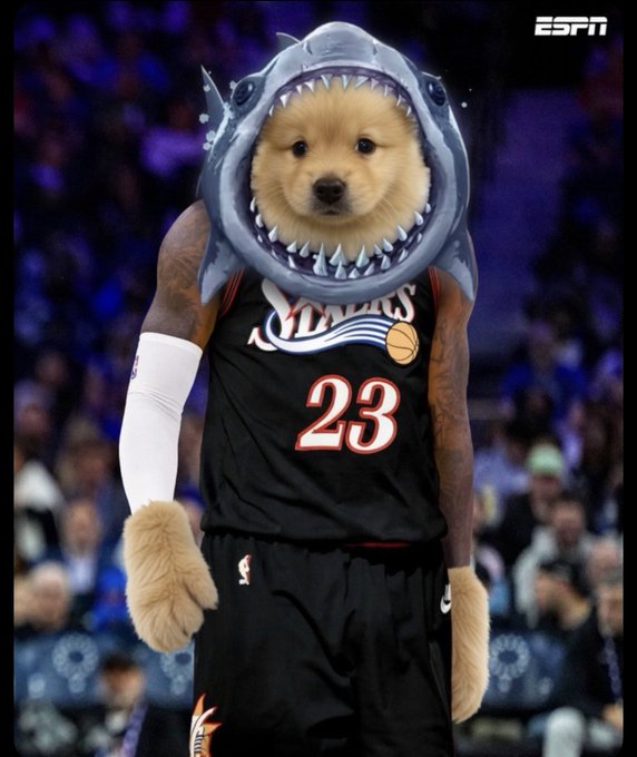 An ESPN-branded edited image of a basketball player in a Philadelphia 76ers #23 jersey, with a dog's face and paws edited onto the player wearing a shark costume headpiece.