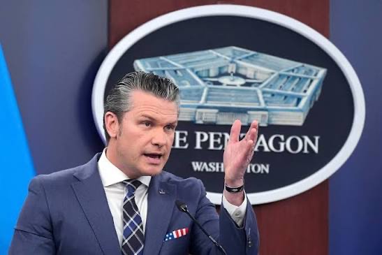 Defense Secretary Pete Hegseth speaks at a Pentagon press briefing in Washington, standing before the official Department of Defense seal, amid news that the Pentagon is demanding universities like Harvard and MIT sever ties with China, Russia, and Iran or risk losing federal funding.