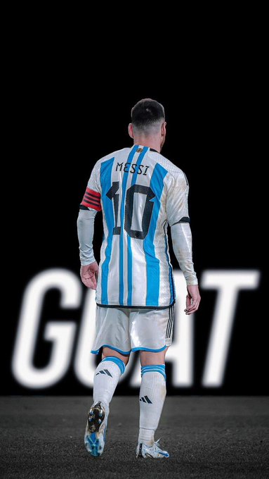 The image features a soccer player wearing a blue and white striped jersey with the number 10, walking across a field. The background of the photo is black, which contrasts with the player's attire. There are no other objects or people visible in the image, making the focus on the soccer player and his uniform the primary subject matter.