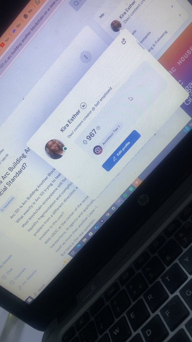 A laptop screen displays Kira Esther's Dev content creator profile with a follower count of 3,967 and an "Architect Tier 1" badge, alongside a BlueWillow post about Arc Building Africa's AI building standards, reflecting her recent achievement as shared in the accompanying post.