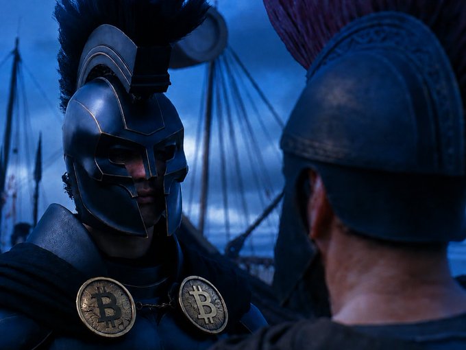 A Spartan warrior in battle armor featuring Bitcoin "₿" medallions stares down an opponent, set against a moody blue ship rigging backdrop. The image humorously visualizes the "holding" mantra of Bitcoiners, depicting Odysseus as a HODLer steadfastly weathering the crypto storm.