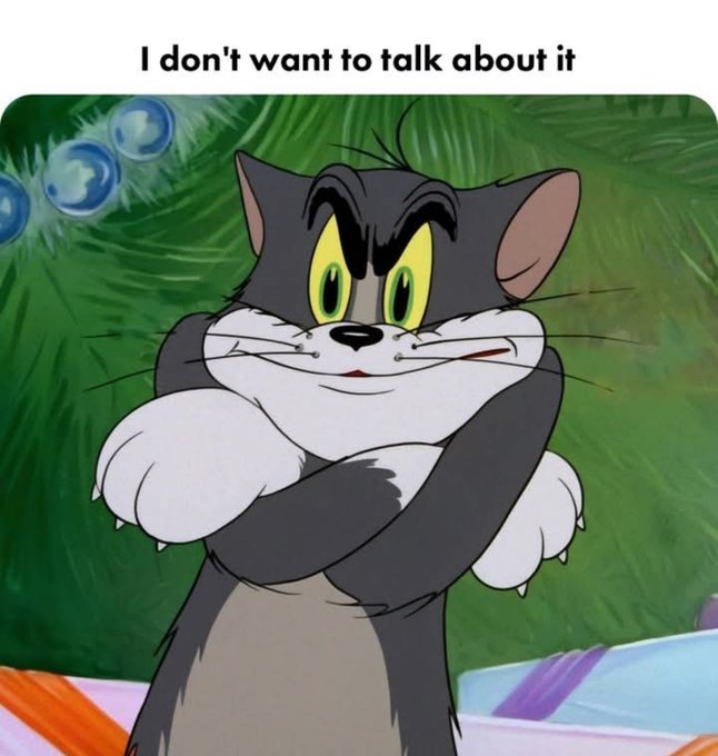 A meme featuring Tom from the classic cartoon Tom and Jerry with his arms folded defensively, accompanied by the caption "I don't want to talk about it."