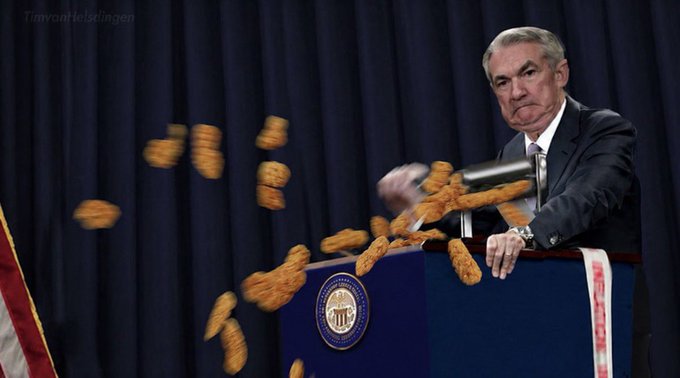 A manipulated image of Federal Reserve Chairman Jerome Powell at a podium with the Federal Reserve seal, with coins appearing to fly out of a gavel as he swings it down.