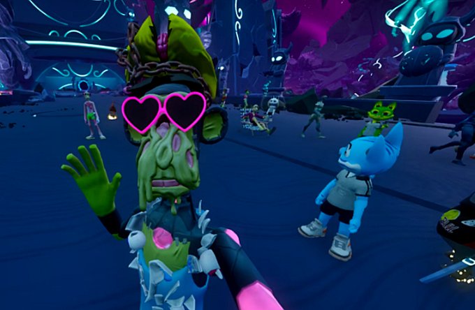 A screenshot from a 3D video game showing a green-skinned character with a stitched face wearing pink heart-shaped sunglasses and waving, alongside a blue cat-like character in a neon-lit environment.