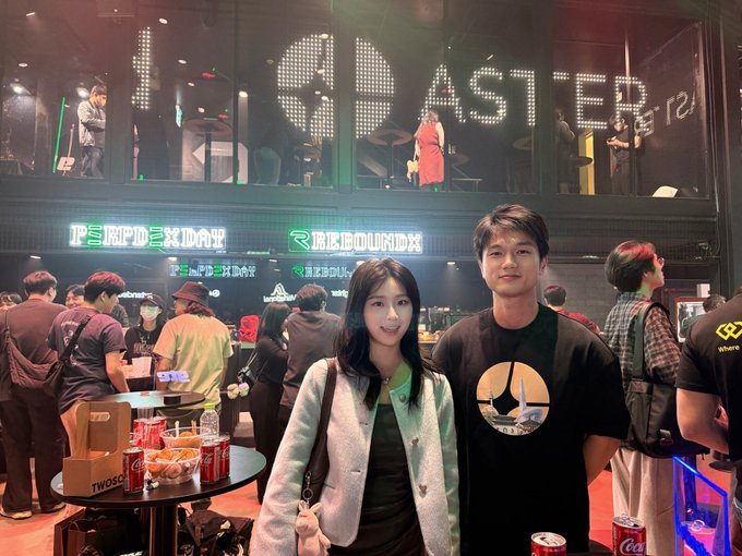 Two people posing together at what appears to be a gaming or esports event with 'UNLIMITED' and 'MADE IN HEAVEN' signage visible in the background.