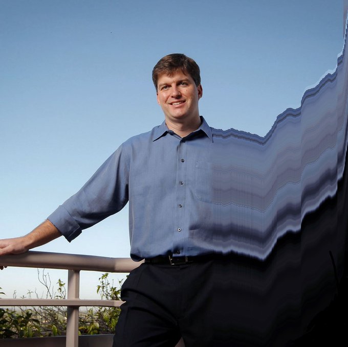 The image features a man standing next to a railing, smiling at the camera. He is dressed in a blue shirt and black pants. The background of the photo shows a clear sky with no clouds, providing a nice contrast to the man's attire. The caption "head and shoulders" suggests that this might be an advertisement or promotional material for a clothing brand or store.