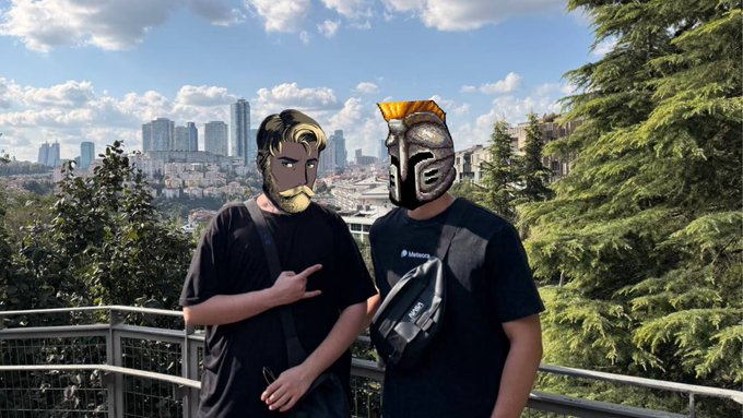 Two masked figures in wrestling-style masks pose on a balcony overlooking Istanbul's skyline, showing off a black Packetchat fanny pack in a nod to the post's shoutout to packet merchandise.