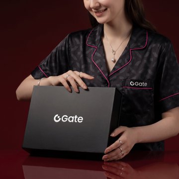 A promotional photo showing a smiling woman in black satin pajamas with pink piping holding a 'Gate' branded gift box against a dark red background.