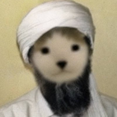 A simple needle-felted doll with a white fabric turban and scarf, black button eyes, a stitched mouth, and a black beard against a plain beige background.