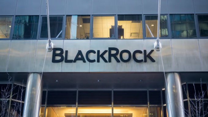 A photograph of the exterior of a BlackRock office building with the company's name mounted on a metal panel above glass doors.