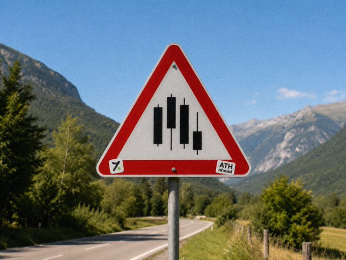 A triangular road-warning sign shows a rough or uneven roadway, with an “ATH ahead” sticker and a small “7” logo. It visually reinforces the post: “GM traders — Road may get bumpy, but ATH is still ahead.”