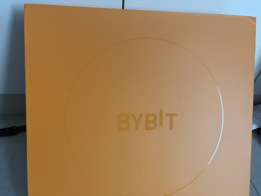 An orange box featuring the "BYBIT" logo inside a circular outline.
