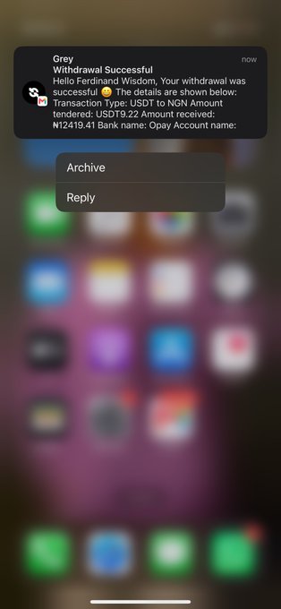 An iPhone notification from 'Grey' confirming a successful withdrawal of USDT19.22 (~$19.41) to a bank account.