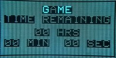 A pixelated retro-style digital display showing 'GAME' and 'TIME REMAINING' with placeholders for hours, minutes, and seconds.