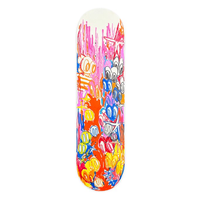 A skateboard deck featuring vibrant, graffiti-style artwork with cartoonish characters in pink, orange, yellow, and blue colors.