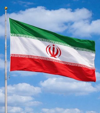 The flag of Iran waving against a blue sky with clouds, featuring horizontal green, white, and red stripes with the red national emblem in the center.
