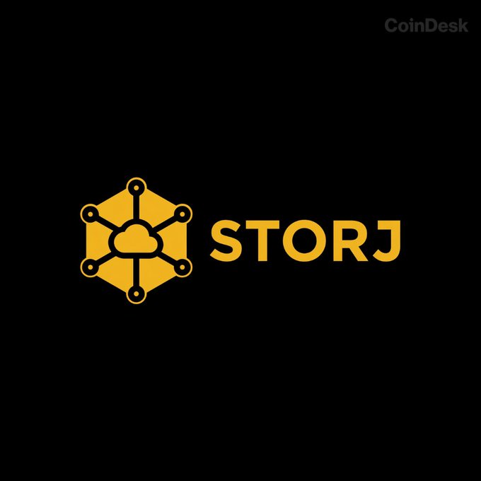 The image displays the Storj logo—a yellow hexagonal emblem with a cloud at its center—alongside the "STORJ" ticker name on a black background, with a "CoinDesk" watermark in the top right corner. It appears to be a reference image tied to a post suggesting a potential crypto market bottom, where Storj may be one of the altcoins being highlighted as either beaten down or showing signs of recovery amid anticipated FED easing.