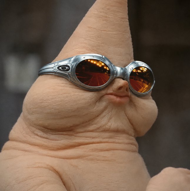 A bizarre, fleshy organic creature wearing round reflective sunglasses is featured, likely a meme about crypto traders (CT) being mocked by "normies" who front-run their trades. The unsettling image serves as a humorous visual representation of an unfamiliar or alien crypto "alpha" character that insiders are promoting while outsiders try to capitalize on the trend.