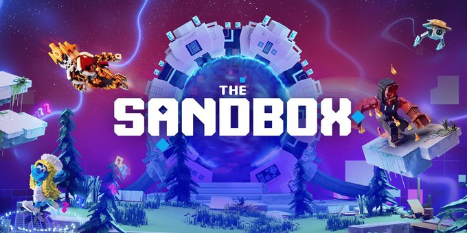 The image features promotional artwork for "The Sandbox" with the game's title displayed prominently in white text across a vibrant, purple-hued voxel-style scene. The artwork showcases various blocky characters, a floating sci-fi vehicle, and a character in a yellow suit on a platform, all set against a cosmic backdrop with a glowing portal behind the title, reflecting the game's user-generated voxel world-building platform that is gaining traction ahead of its public beta.