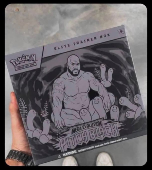 A hand holds a gray 'Pokémon Trading Card Game Elite Trainer Box' titled 'Mega Evolution Phich Black,' featuring an illustration of a muscular bearded man surrounded by small creatures.