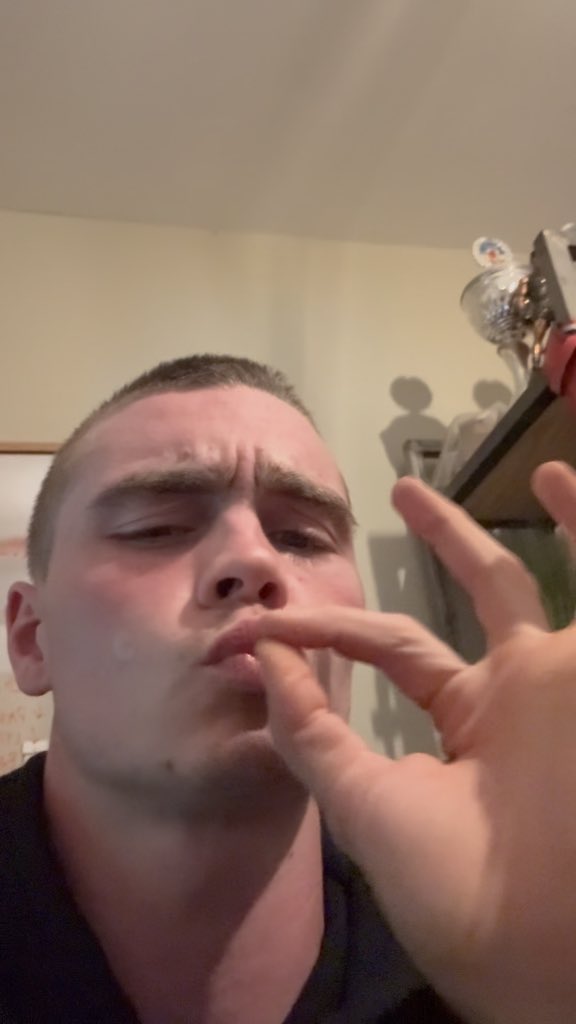 A close-up selfie of a young man with short hair, holding his hand near his face while crossing his eyes and pursing his lips in a goofy expression.