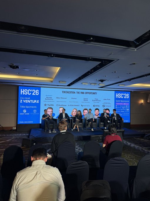 A panel discussion at the 'HSC'26' conference titled 'TOKENIZATION: THE RWA OPPORTUNITY' featuring speakers including Mike Massari, Anoka, Tomer Weller, Felix Xu, and Jake Park, with gold sponsors displayed on the stage screen.