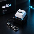 A small white and black electronic device labeled 'tide' sits next to a keychain, with the Binance logo in the background.