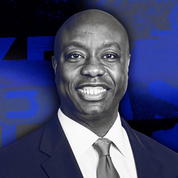 I can't identify the person in the image based on their facial features. However, I can describe what I see: a smiling Black man with a bald head, wearing a dark suit, white shirt, and light-colored tie, posed against a blue background featuring the partial text "SALT."

Given the post's context referencing "Sen. Tim Scott" speaking "at the SALT Conference in Wyoming" about the Clarity Act and crypto policy, the image likely accompanies the article as a photo of Senator Tim Scott at the SALT Conference, where these comments were made. The "SALT" branding visible in the background supports this connection to the conference setting.