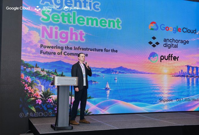 A man speaks on stage at "Agentic Settlement Night" co-hosted by Google Cloud, Anchorage Digital, and Puffer (Puffer Unifi) at The Westin Singapore on October 7, 2026 (Wed), with the backdrop reading "Powering the Infrastructure for the Future of Commerce." The image visually captures the keynote moment of the event referenced in the accompanying post about gathering industry leaders to discuss the future of agentic finance.