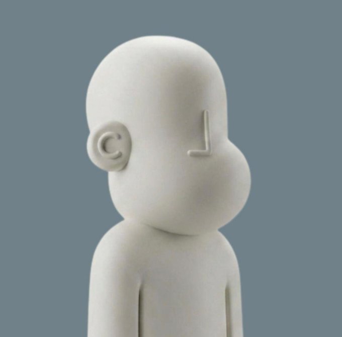 A minimalist 3D-rendered white figurine with a rounded head, small C-shaped ear, and no facial features stands against a solid blue-gray background.