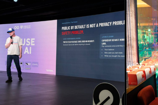 Conference scene showing a speaker presenting on stage with slides reading 'HOUSE AI' and 'PUBLIC BY DEFAULT IS NOT A PRIVACY PROBLEM. SAFE BY DEFAULT.'