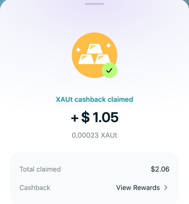 A mobile app screenshot showing a successful gold cashback claim with text: 'XAut cashback claimed +$1.05 (0.00023 XAut)' and 'Total claimed $2.06'.