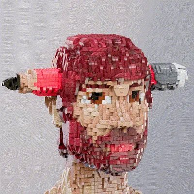 A 3D pixel-art style sculpture/portrait of a character with red and peach tones, appearing to hold two objects (possibly weapons or tools) on either side.