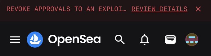 A screenshot of the OpenSea website header with a red warning banner that reads "REVOKE APPROVALS TO AN EXPLOI... REVIEW DETAILS".