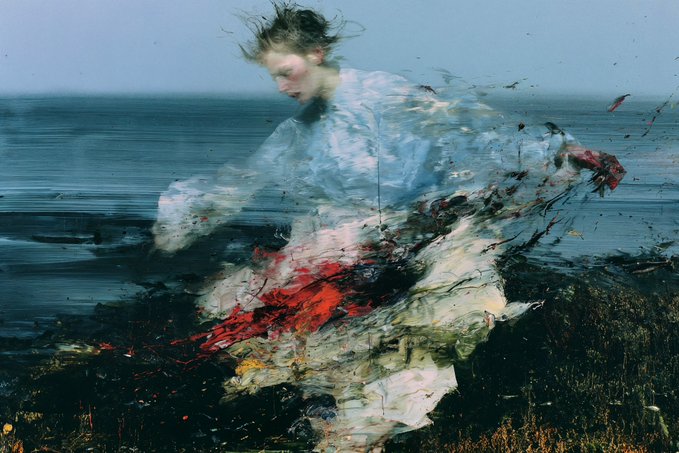 An expressive, impressionistic painting or digital artwork depicting a figure in a flowing white garment dissolving into red and dark splashes against a coastal backdrop.