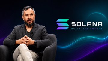 A bearded man in a gray cardigan and white pants sits in a chair beside the Solana logo with the tagline "SOLANA BUILD THE FUTURE," as he appears to be interviewed about his influences and the vision for the blockchain platform.