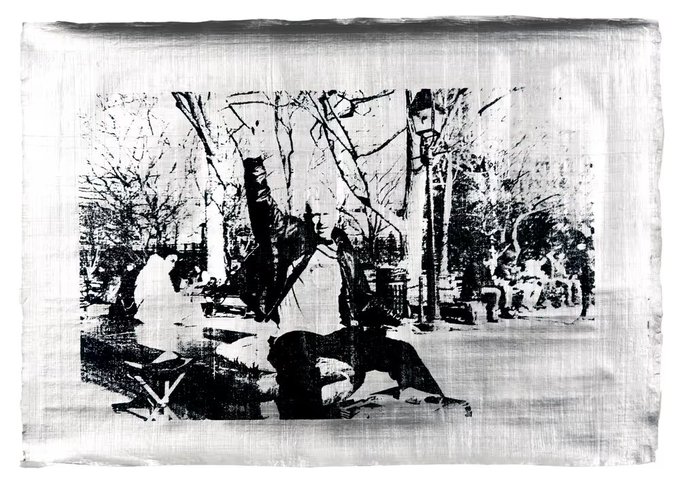 A grainy, high-contrast black-and-white photograph of a park scene with bare trees, where figures appear seated and standing on benches in the foreground.