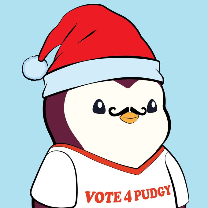 An illustrated cartoon penguin wearing a red Santa hat and a shirt reading "VOTE 4 PUDDY" against a light blue background.