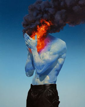 A muscular figure with a blue-tinged body holds a flaming, smoke-emitting sphere where their head would be against a dark blue background.